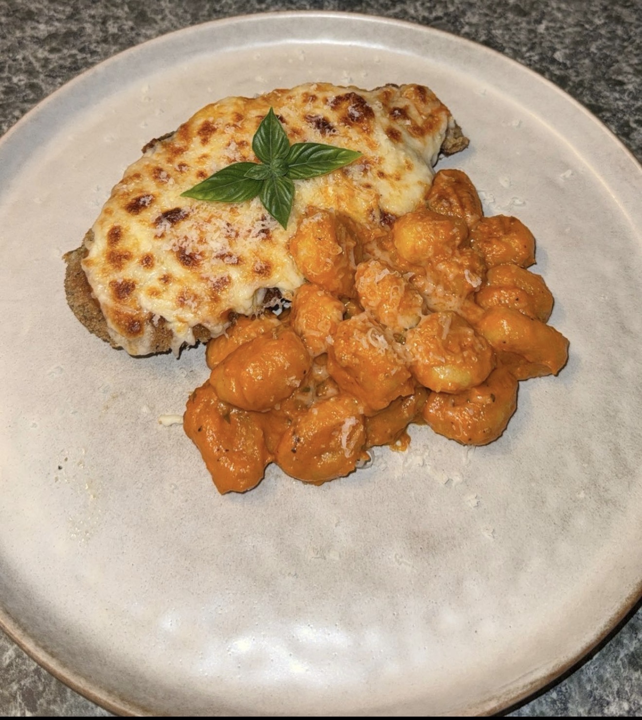 Chicken parmesan with vodka-sauced gnocchi and basil